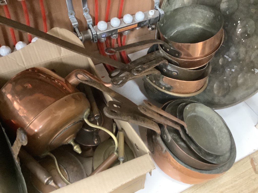 A large mixed collection of antique copper wares to include saucepans, kettles, etc.